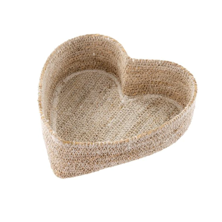 A white heart shaped basket against a white background