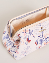 Load image into Gallery viewer, A small toiletry bag with a beautiful floral pattern in shades of pinks and blues open to show the inside and zipper closure

